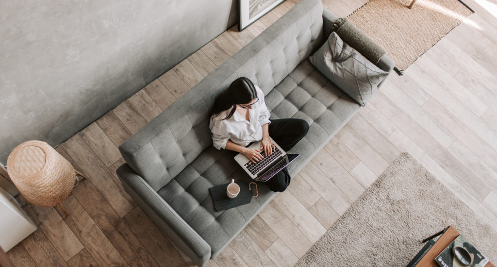 Woman sitting on couch searching through marketing strategies