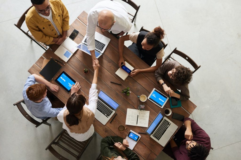 Team around a table discussing a new pay-per-call campaign