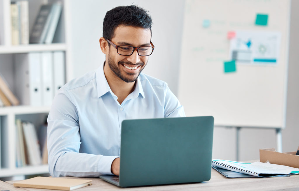 Business man typing on laptop, researching how to make money with pay-per-call