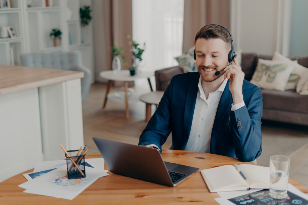 Professional businessman watches videos on his computer on how to form a pay-per-call strategy